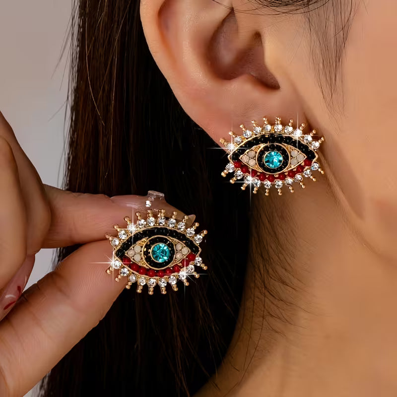 Boucles d'oreilles œil maléfique en strass