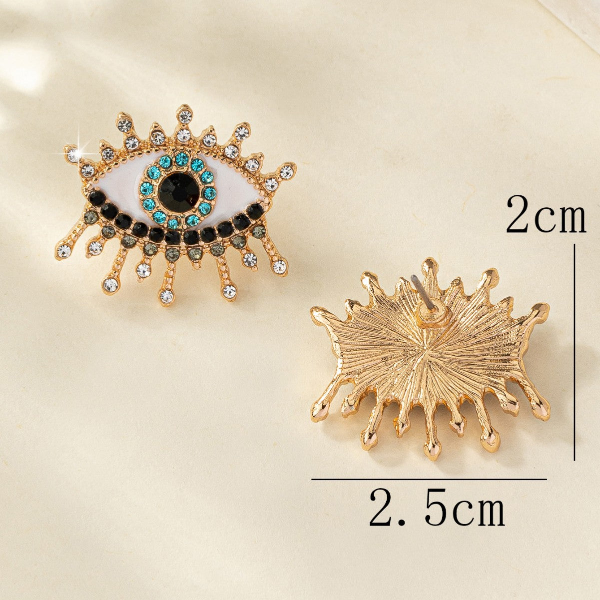 Boucles d'oreilles œil maléfique en strass